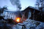 Anti-government protesters warm themselves at a fire at a barricade on Hrushevskoho Street on January 29, 2024 in Kiev, Ukraine.