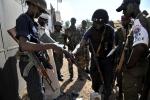 Soldiers of the multinational African force (FOMAC) and Central African policemen check on October 7, 2024 in Bangui weapons and ammunitions seized to Seleka rebels during a disarmament operation in the capital and its neigbourhood earlier in the day.