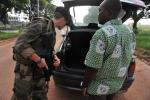 A French soldier of the BOALI operation in Central African Republic checks a car at a checkpoint near Bangui Airport on October 10, 2013. 