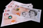  In this photo illustration, a sample Polymer ten pound British banknote sits on original ten pound British paper banknotes during a news conference at the Bank of England on September 10, 2024 in London, England.
