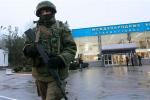 An armed man patrols at the airport in Simferopol, Crimea. A group of armed men in military uniforms have seized the main regional airport in Simferopol.An armed man patrols at the airport in Simferopol, Crimea. A group of armed men in military uniforms have seized the main regional airport in Simferopol.