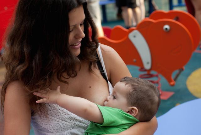 A mother breast feeds her child during a protest outside a Primark Store on August 23, 2024 in Madrid, Spain.
