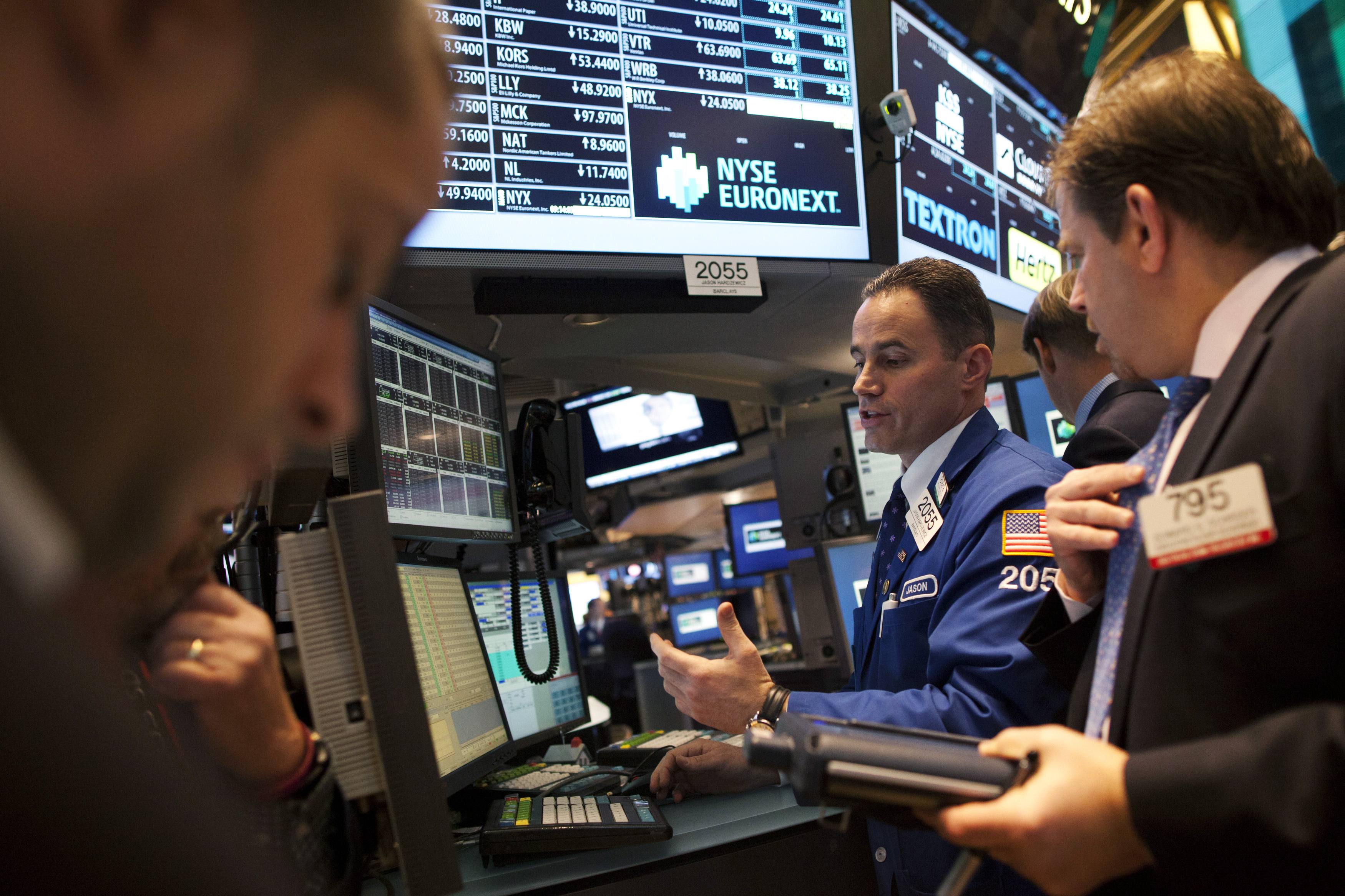 Traders work the floor at the New York Stock Exchange in New York.