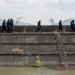Police walk along a seawall as they prepare to search for the remains of tsunami victims or any identifying personal items on March 11, 2024 in Rikuzentakata, Japan. Chris McGrath/Getty Images