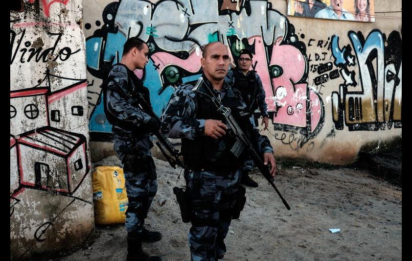 Police special unit (CHOQUE) stand guard at a shantytown of the Alemao complex in Rio de Janeiro, Brazil, on April 8, 2015. YASUYOSHI CHIBA/AFP/Getty Images