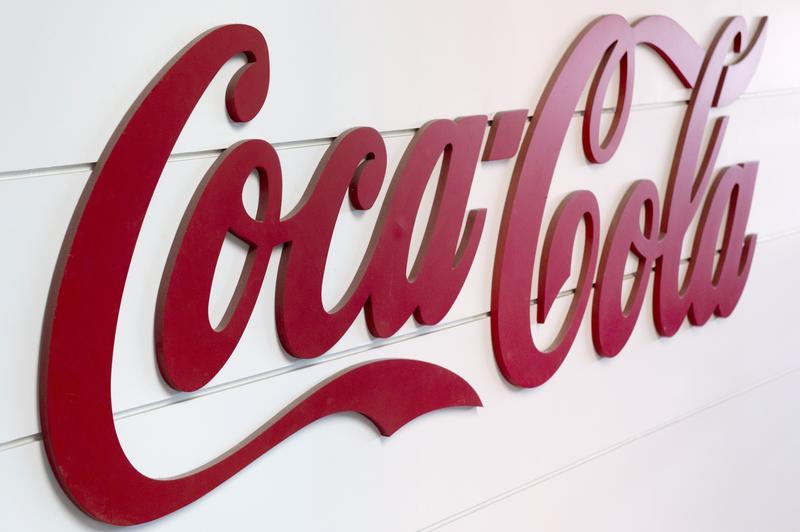This photo taken on June 7, 2013, in Clamart, near Paris, shows the Coca-Cola logo on the side of an assembly line at a Coca Cola bottling plant. AFP PHOTO / LIONEL BONAVENTURE