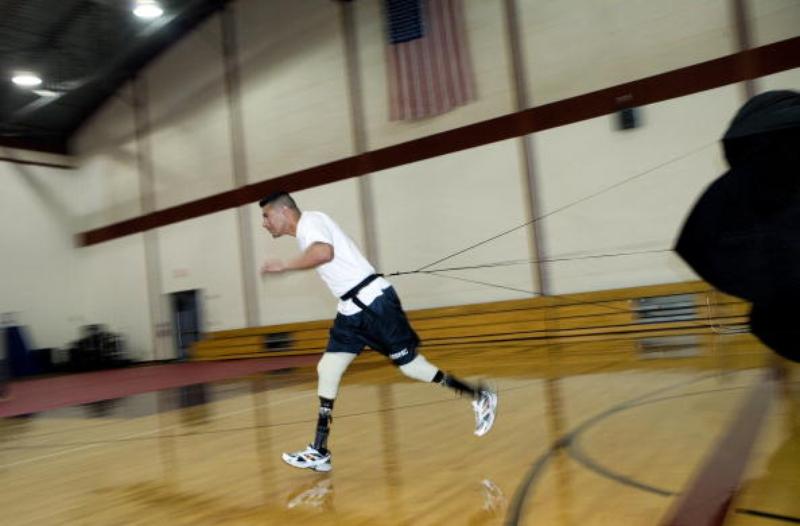U.S. Marine Sgt. Angel Barcenas, who lost both his legs as a result of and IED blast in Iraq, runs with a parachute during a demonstration at Walter Reed Army Medical Center June 1, 2024 in Washington, DC. Patients and staff of Walter Reed were joined by athletes to demonstrate how amputees excercise to and learn to use prosthetic limbs while also showing the latest technology behind the prosthetics. Getty Images