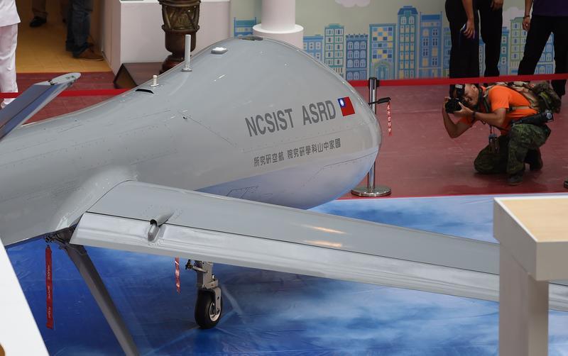 A photographer takes photo of the latest home made MALE Unmanned Aircraft Systems during a press conference of the 2015 Taipei Aerospace and Defense Technology Exhibition at the World Trade Center in Taipei on August 12, 2015. AFP PHOTO / Sam Yeh