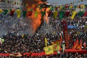 Some thousands of supporters demonstrate waving various PKK flags and images of jailed Kurdish rebel leader Abdullah Ocalan, in southeastern Turkish city of Diyarbakir, Turkey, Thursday, March 21, 2013, as Ocalan called Thursday for an immediate cease-fire and for thousands of his fighters to withdraw from Turkish territory, a major step toward ending the fighting for self-rule for Kurds in southeastern Turkey, one of the world's bloodiest insurgencies lasting nearly 30-years and costing tens of thousands of lives. A Nowruz fire seen in the background. Nowruz, the Farsi-language word for "new year", is an ancient Persian festival, celebrated on the first day of spring, March 21, in Central Asian republics, Iraq, Turkey, Afghanistan and Iran. (AP Photo)