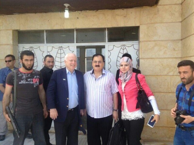U.S. Senator John McCain (front, 2nd L), an outspoken advocate for U.S. military aid to the Syrian opposition, meets with Free Syrian Army General Salim Idris (2nd R) and Razan Shalab AlSham, Field Director of Syrian Emergency Task Force (R) during a surprise visit to Syria in this May 27, 2024 handout photo. Mouaz Moustafa/Syrian Emergency Task Force/Handout via Reuters