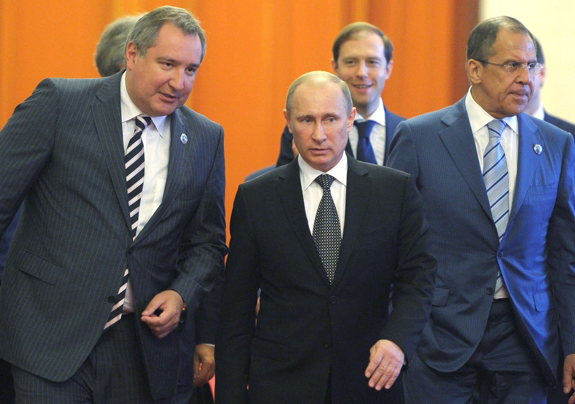 President Vladimir Putin (C) speaks with Deputy Prime Minister Dmitry Rogozin (L) in Beijing, on June 6, 2012. (AFP/GettyImages: ALEXEY DRUZHININ)