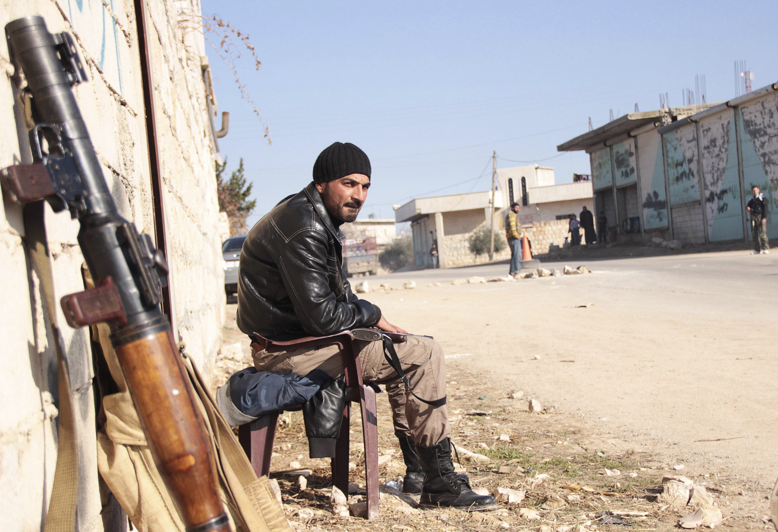 A rebel fighter guards a street to prevent members of the al Qaeda-affiliated Islamic State of Iraq and the Levant from entering Jabal al-Zawiya in Idlib