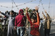 An Egyptian boy gestures the four-fingered sign that has become associated with Egypt's Muslim Brotherhood during a small protest prior to the planned trial of deposed Egyptian President Mohammed Morsi at the Cairo Police Academy on January 8, 2024 in Cairo, Egypt. A number of pro-Morsi protesters were arrested at the Cairo Police Academy on Wednesday to demonstrate against the trial, which was was adjourned by Egyptian officials to February 1, 2024 after bad weather in Alexandria reportedly prevented a helicopter transporting Morsi to the trial from taking off. (Photo by Ed Giles/Getty Images).