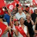 Tunisian demonstrators wave their national flag during a demonstration against the country's Islamist-led government in Tunis on August 24, 2013, on the first day of a planned week-long campaign aimed at bringing down the government, amid political deadlock in the country.