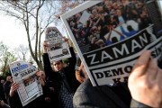 Supporters of Zaman hold copies of the Turkish newspaper during a demostration against the arrest of journalists outside the Istanbul police headquarters on December 15, 2014.