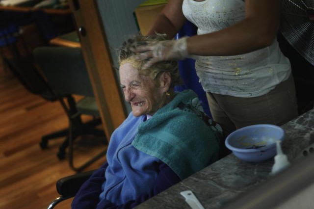An Alzheimer's patient has her hair done inside the Alzheimer foundation in Mexico City, Mexico