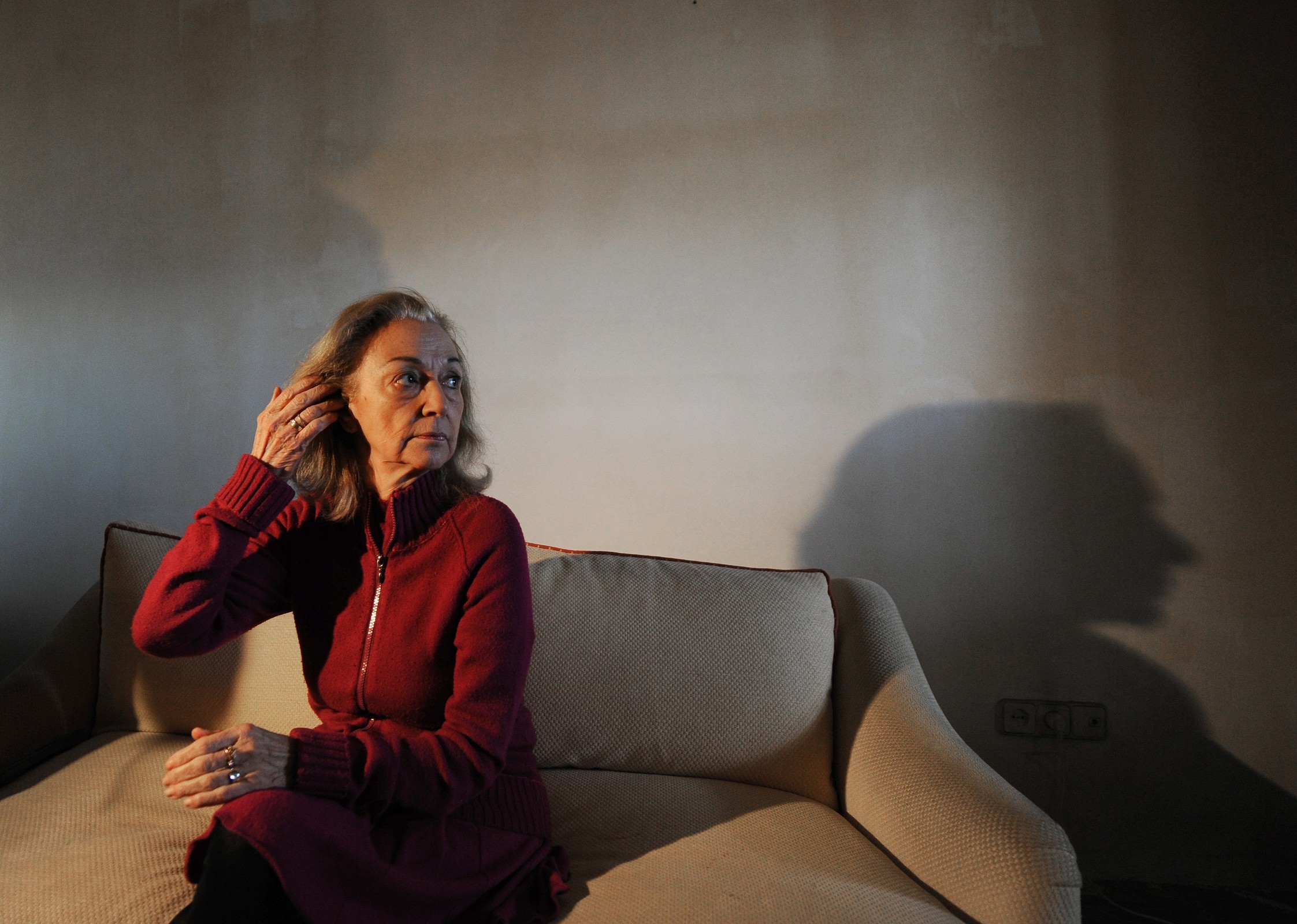 Spanish tenant Monica Briceno, 70, suffering from Alzheimer's disease, sits on her home's couch as she waits for a bailiff to execute her eviction in Madrid on April 5, 2013.(AFP/Getty Images/Dominique Faget)