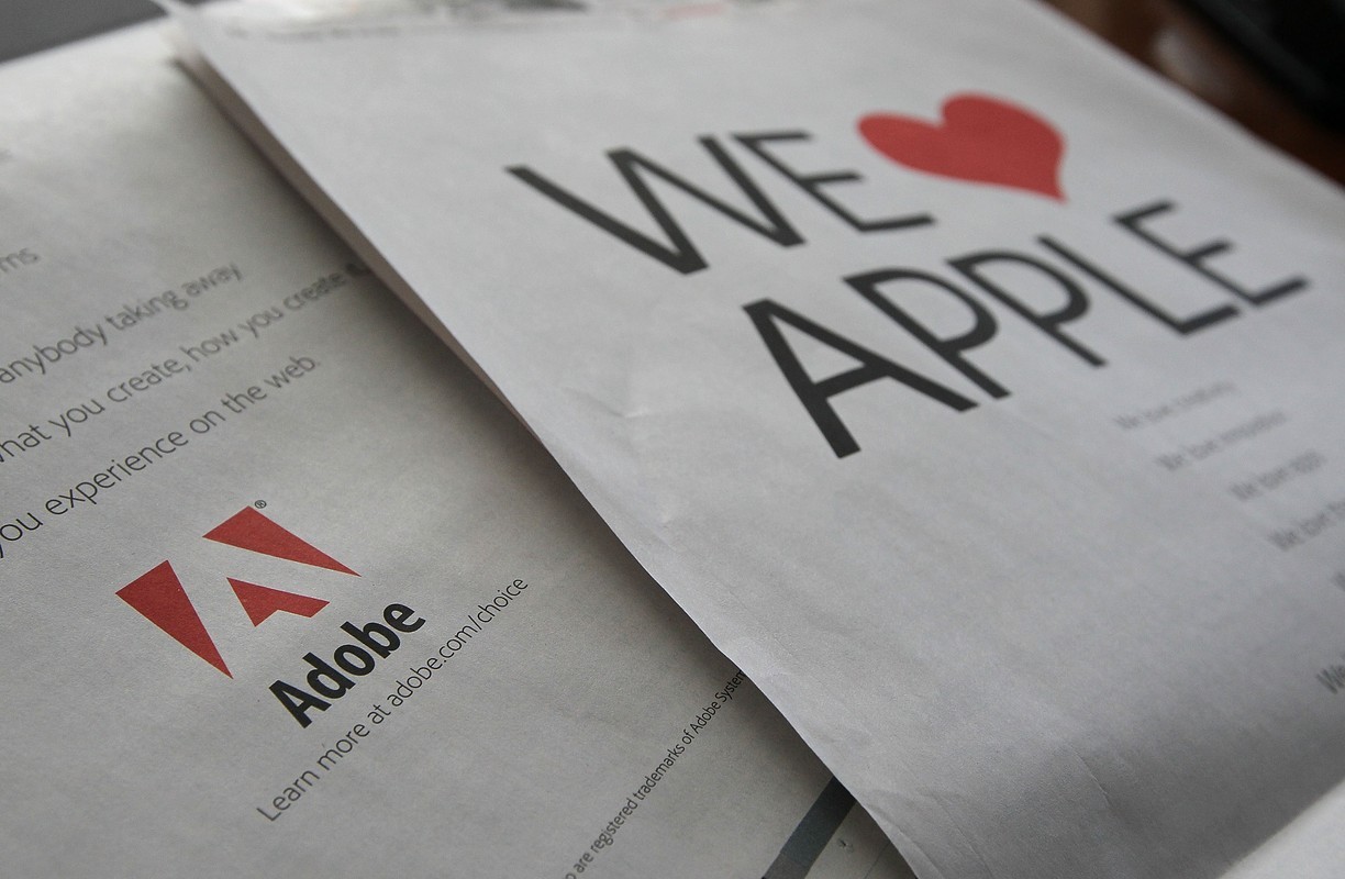 A full page ad aimed at Apple by Adobe Systems is displayed on the back of the San Francisco Chronicle business section. Getty/ Justin Sullivan
