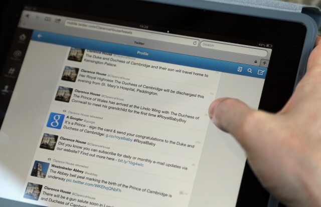 A man looks at Twitter on a iPad of tweets. Getty/ Matt Cardy