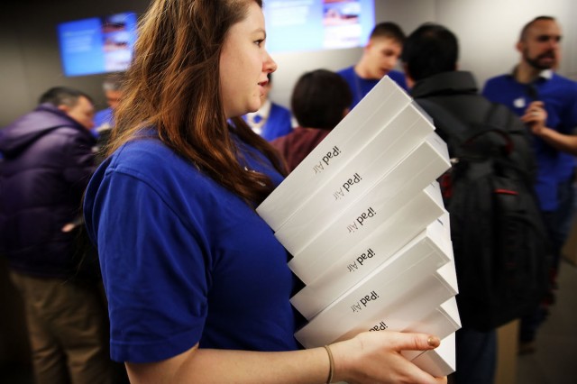 An Apple employee carries boxes of the iPad Air. Spencer Platt/Getty Images