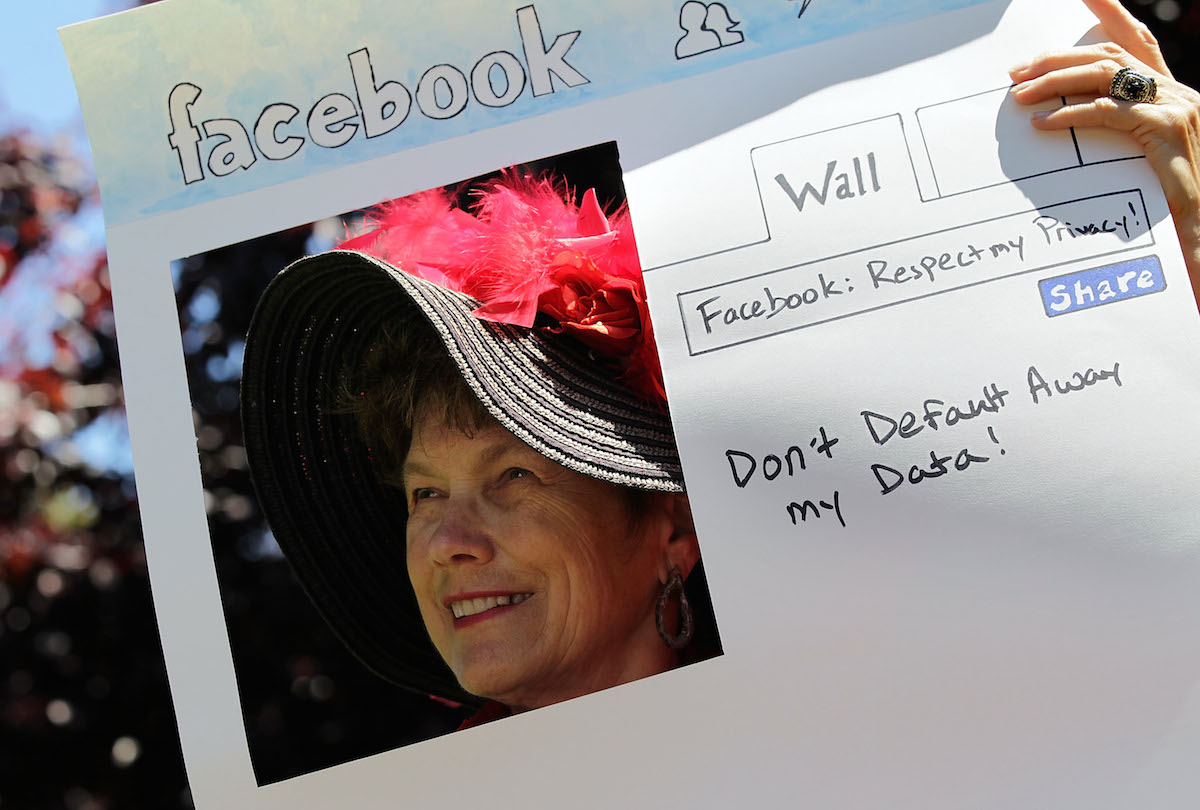 Denely Rafferty holds a sign depicting a Facebook page in Palo Alto, California. Justin Sullivan/Getty Images