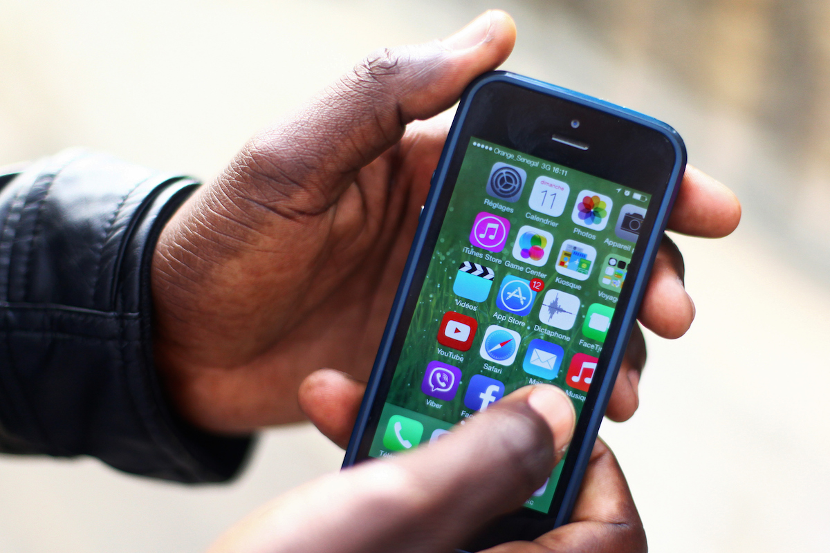 A man demonstrates the use of a smartphone operating with Orange Senegal 3G. Bloomberg via Getty Images