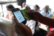 A Kenyan passenger uses a 'BebaPay' card, a mobile phone-based money transfer service. SIMON MAINA/AFP/Getty Images