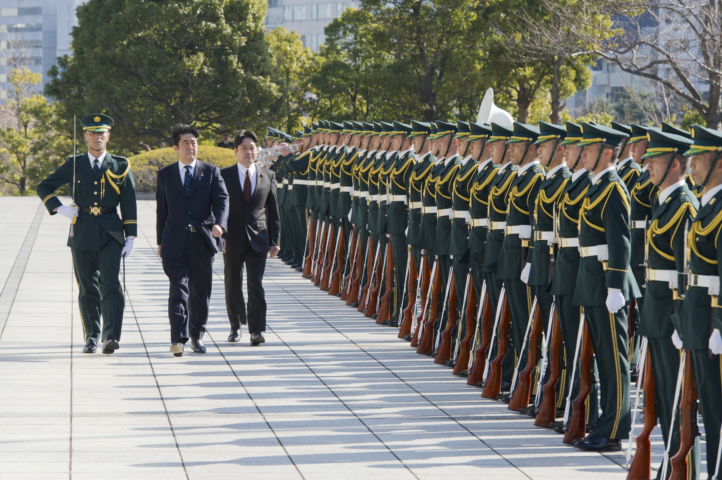 Japan's P.M. Abe reviews the honour guard at the Defense Ministry in Tokyo.