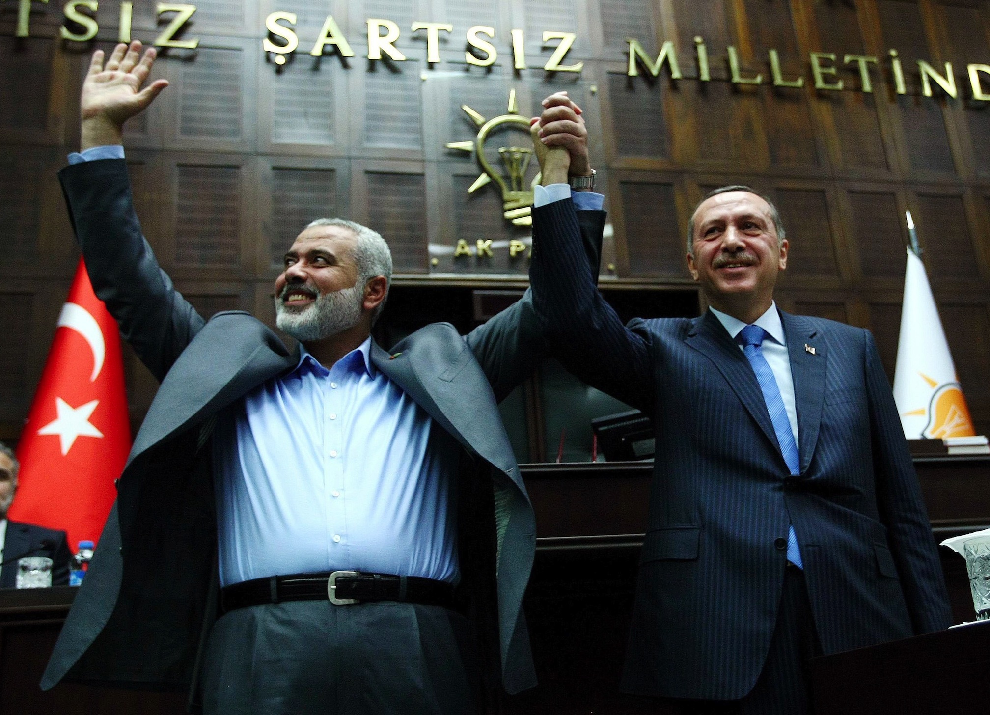 The Gaza Strip's Hamas Prime minister Ismail Haniyeh (L) and his Turkish counterpart Recep Tayyip Erdogan salute together the lawmakers of Erdogan's Islamic-rooted Justice and Development Party at the Parliament in Ankara on January 3, 2012.