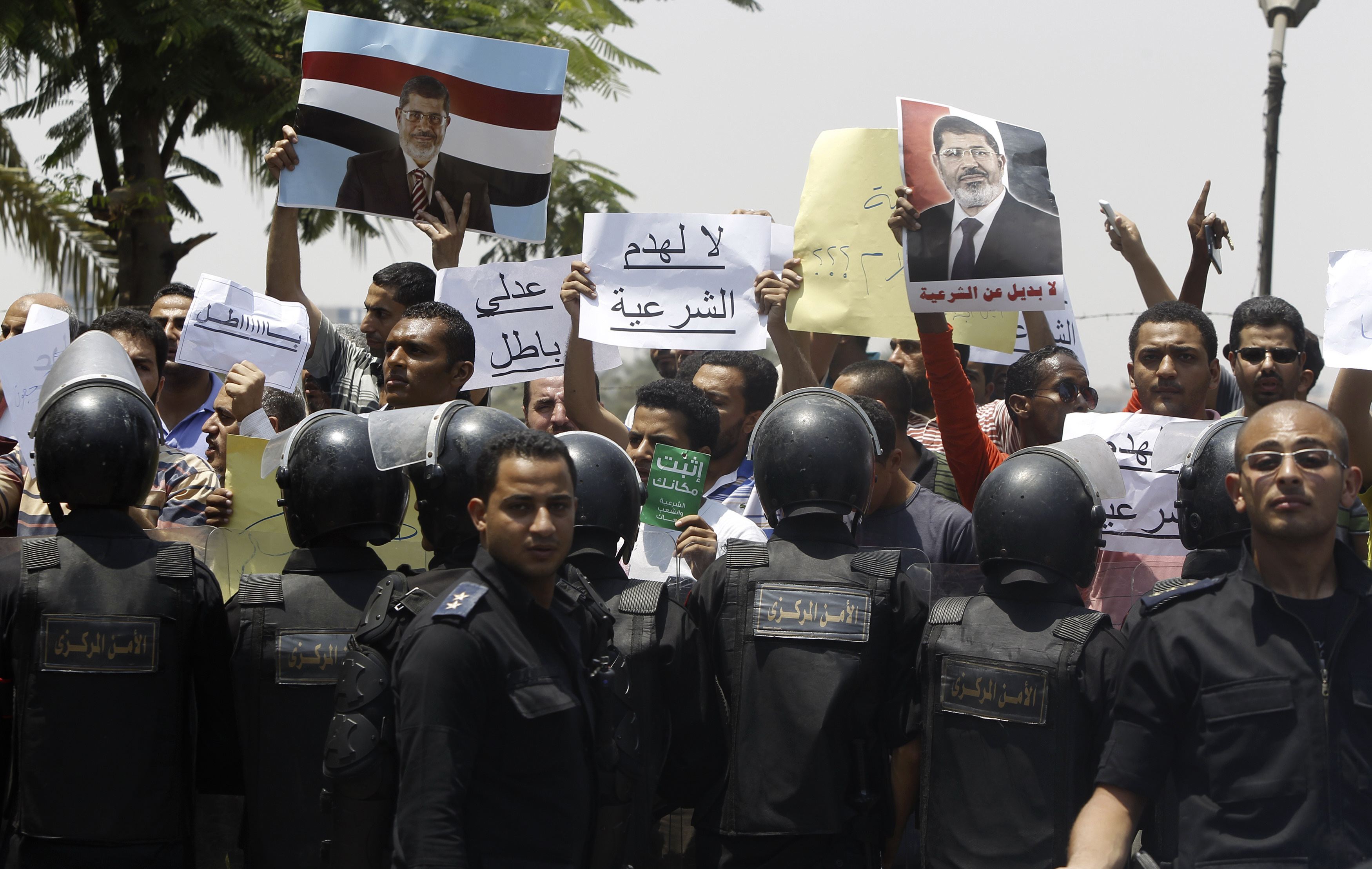 Members of the Muslim Brotherhood and supporters of ousted Egyptian President Mohamed Mursi shout slogans in front of Egypt's Constitutional Court during the swearing in ceremony Adli Mansour as the nation's interim president in Cairo July 4, 2013.