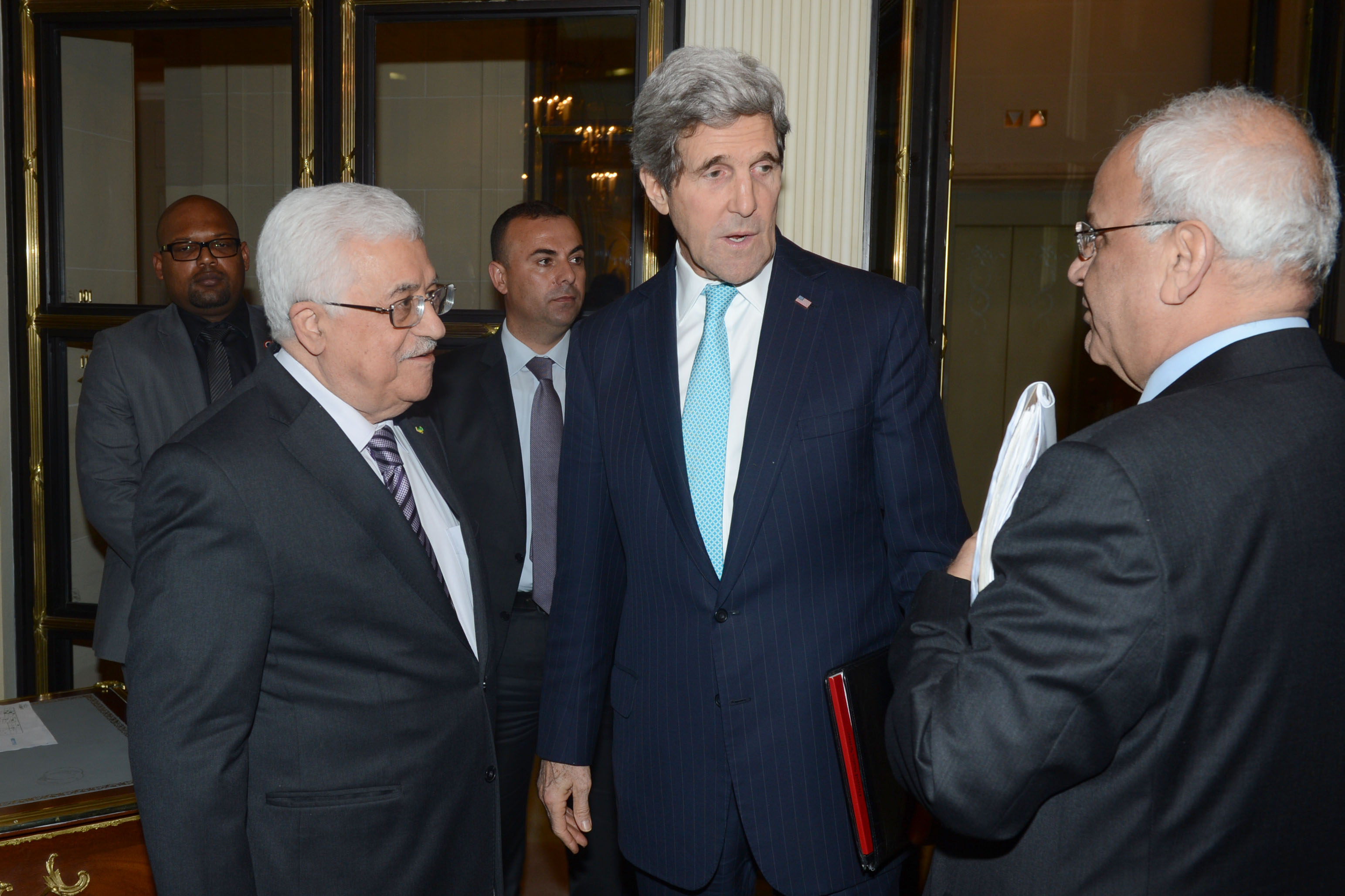 Palestinian leader Mahmud Abbas (L) and US Secretary of State John Kerry (C) talk with Palestinian Chief of Negotiator Saeb Erekat on February 20, 2024 in Paris, France. (Thaer Ghanayim/PPO via Getty Images)