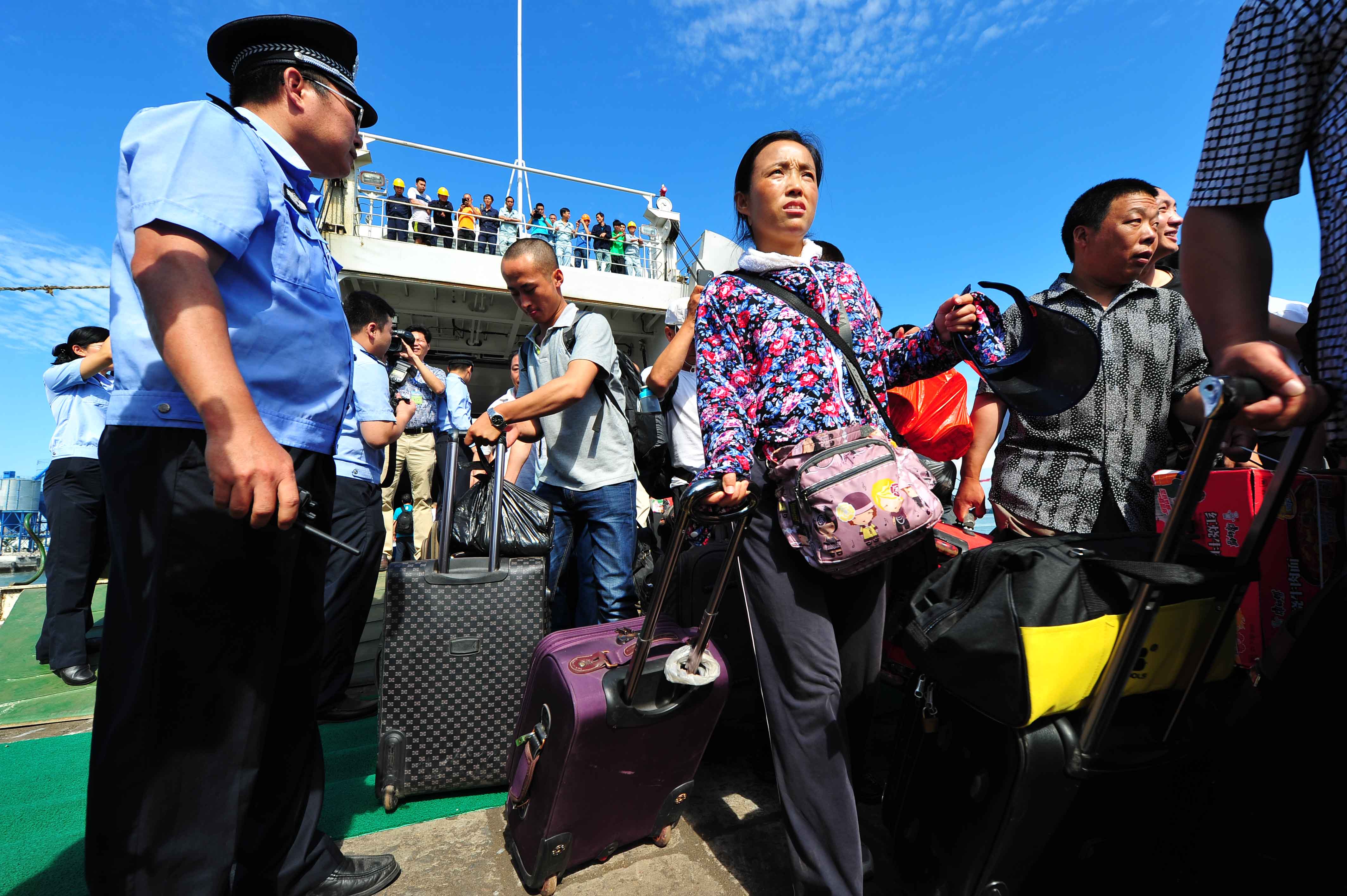 Chinese nationals from Vietnam disembark from a vessel on May 20, 2024 in Haikou, China. (ChinaFotoPress/Getty Images)