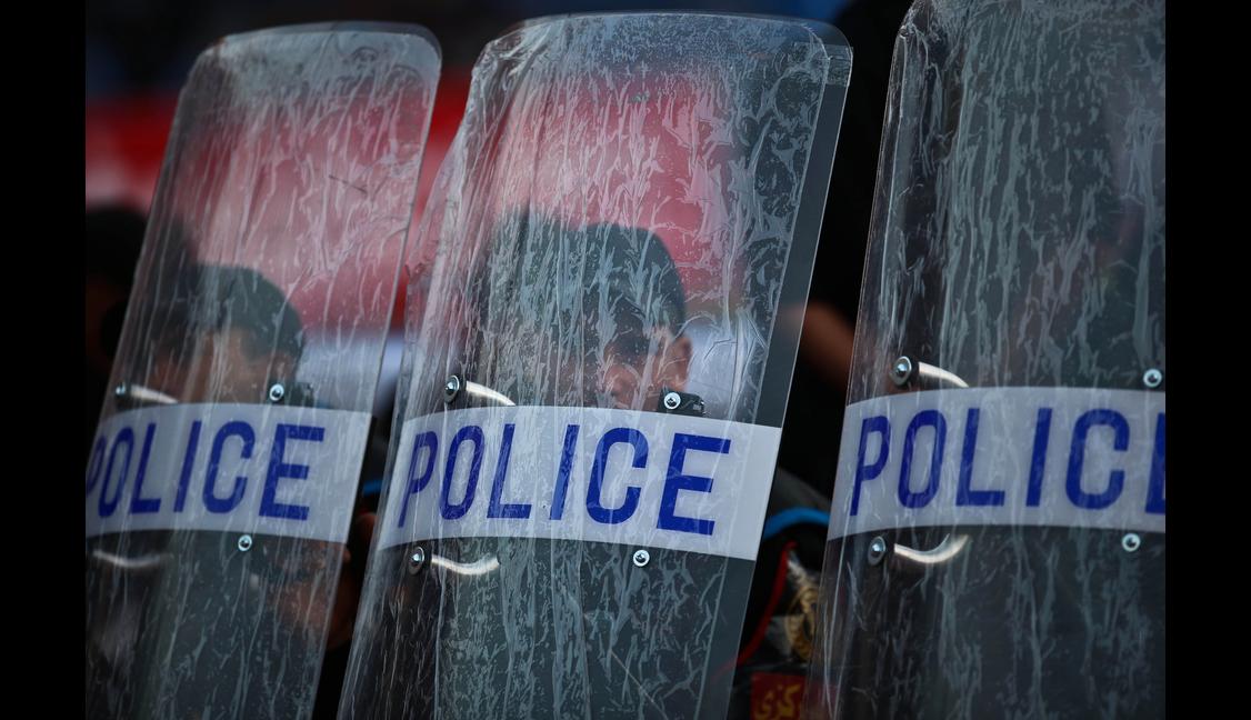 Egyptian policemen stand behind their shields before the start of the second leg of the CAF Confederation Cup final football between Egypt's Al-Ahly and Ivory Coast's Sewe Sport at the Cairo Stadium on December 6, 2014.