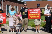 People protest against poaching in the parking lot of Dr. Walter Palmer's River Bluff Dental Clinic in Bloomington, Minnesota. Adam Bettcher/Getty Images