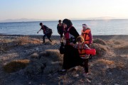A Syrian migrant mother holds the hand of a child as they arrive at a beach on the Greek island of Kos. Getty Images