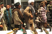 Former Taliban fighters line up to hand over their rifles to representatives of the Afghan government. (Source: FutureTrillionaire/Wikimedia Commons)