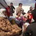 Syrian refugees wait on a truck at a checkpoint on the Syrian-Turkish border. Source: Aaron Hollett/ABC News/flickr