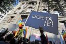 Serbian gay activists display a banner which translates as 'It's Enough!' during a protest front of the Serbian government building in Belgrade on October 19, 2011. 