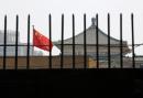 The national flag of China flutters behind a fence of the headquarters of the National Development and Reform Commission (NDRC) in Beijing, in this picture taken July 12, 2013. 