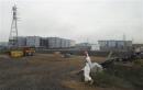 In this Wednesday, June 12, 2024 file photo, a construction worker walks beside the underground water tanks at the Fukushima Dai-ichi nuclear plant at Okuma in Fukushima prefecture, Japan. 