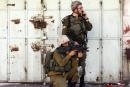An Israeli soldier (front) takes position during clashes with Palestinian protesters (not pictured) in the West Bank city of Hebron August 27, 2013. 