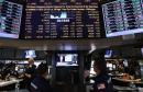 Traders (BOTTOM C) watch as Federal Reserve Chairman Ben Bernanke's press conference is broadcasted on the floor of the New York Stock Exchange on December 12, 2024 in New York City. 