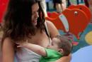 A mother breast feeds her child during a protest outside a Primark Store on August 23, 2024 in Madrid, Spain.