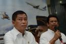 Indonesia's Transport Minister Ignasius Jonan (L) looks on as Director General for Air Transportation Suprasetyo (R) speaks during a press conference in Jakarta on August 16, 2015, announcing that a missing plane carrying 54 people has crashed into a mountain in eastern Indonesian province of Papua.