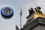 An inflatable balloon with the Argentine national oil company YPF logo floats in the air in front the Congress building  on May 3, 2024 in Buenos Aires.
