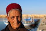 An old man rests at the Hergla's port on December 17, 2024 in Hergla, Tunisia. Hergla is a small cliff-top town in northeastern Tunisia off the Gulf of Hammamet.