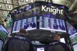 A pair of Knight Capital traders work at their post on the floor of the New York Stock Exchange before the close of trading, Friday, Aug. 3, 2012. Knight Capital's stock soared after the battered trading firm received a financial lifeline and clients said they expect to resume routing trades through the system. 