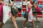 Shoppers walk down Broadway in Manhattan, New York City.