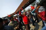 Members of a splinter faction of the Unified Communist Party of Nepal Maoist shout slogans as they protest against the formation of an interim government in Katmandu, Nepal, Thursday, March 14, 2013.