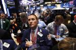 Traders work on the floor at the New York Stock Exchange, April 12, 2013.